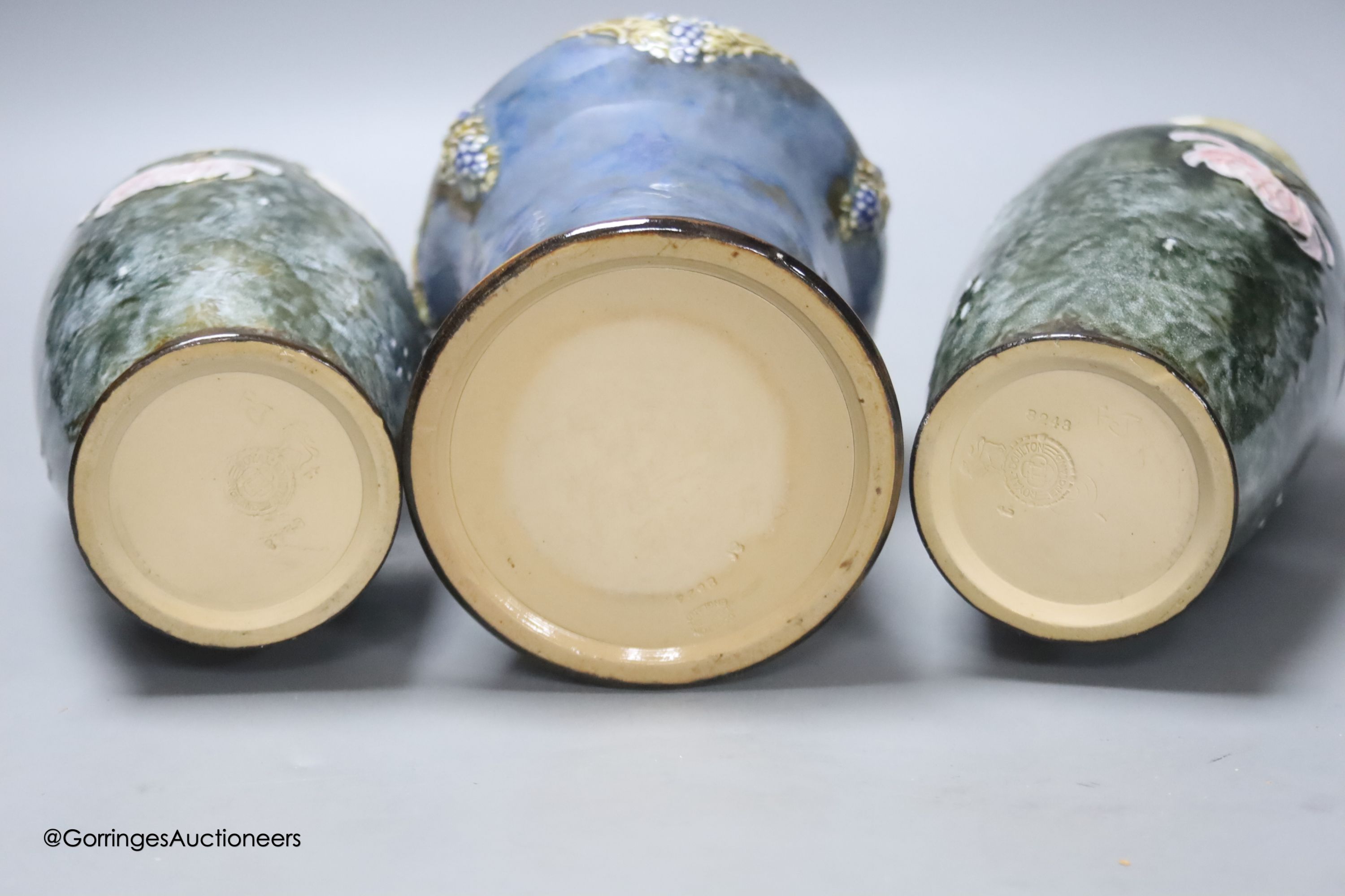 A pair of Doulton vases, 23cm high, together with a Doulton flask, 22cm high (3)